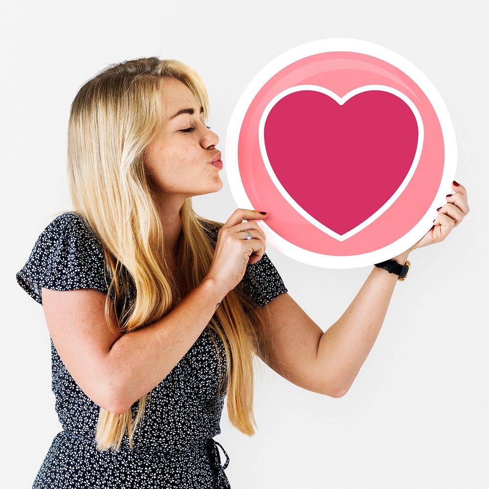 Blond woman holding heart icon