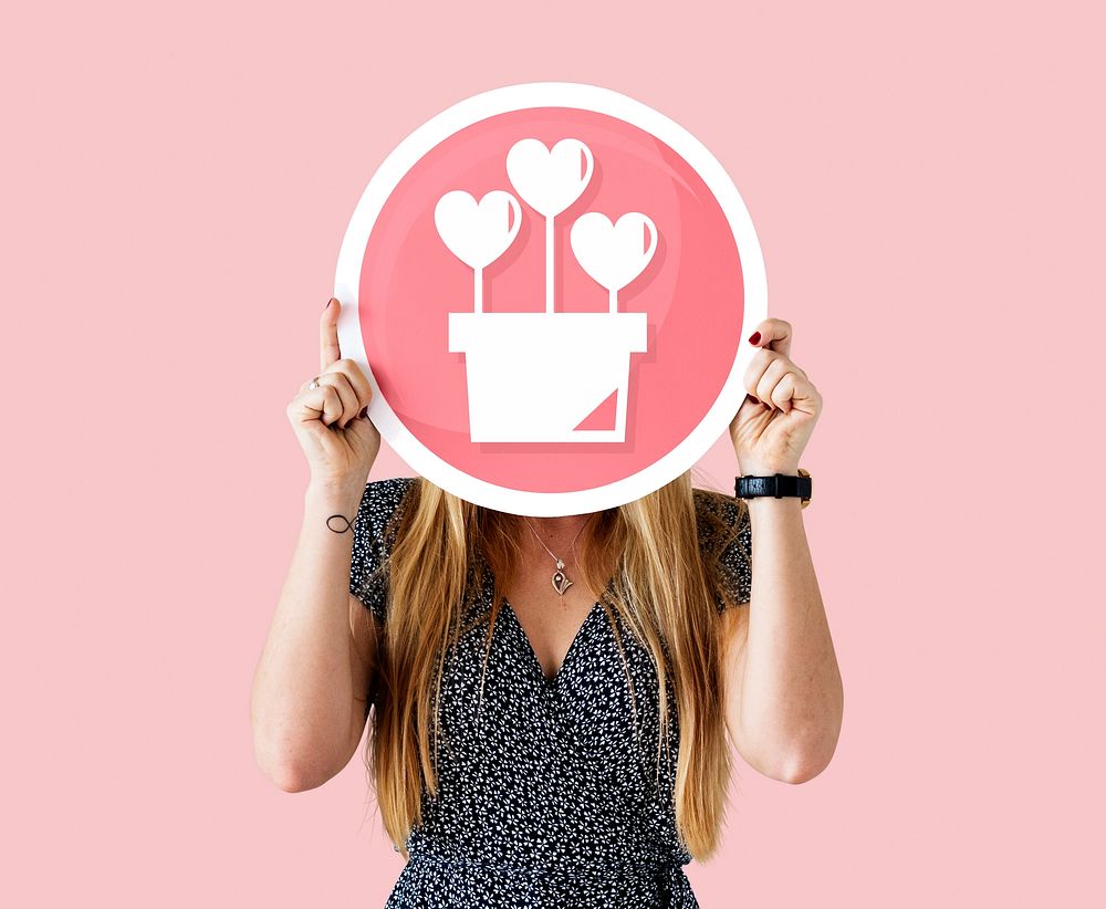 Cheerful woman holding valentine's icon