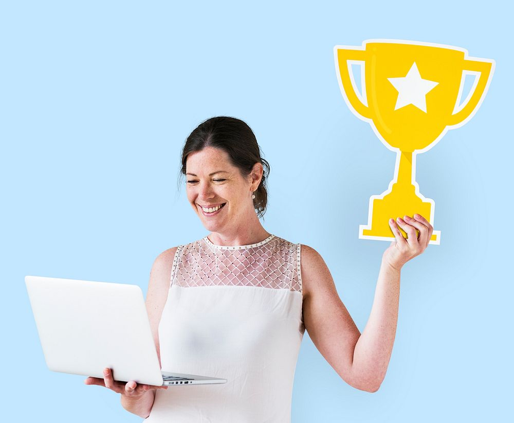 Woman holding a trophy icon and using a laptop