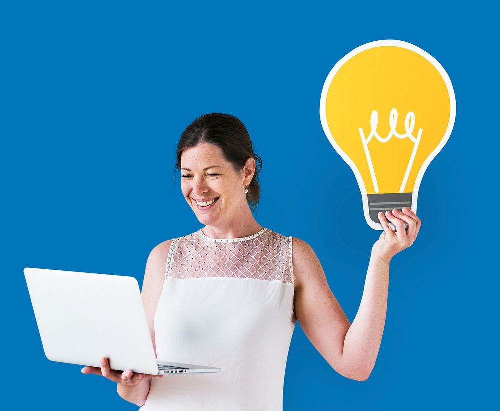 Woman holding an idea icon and using a laptop