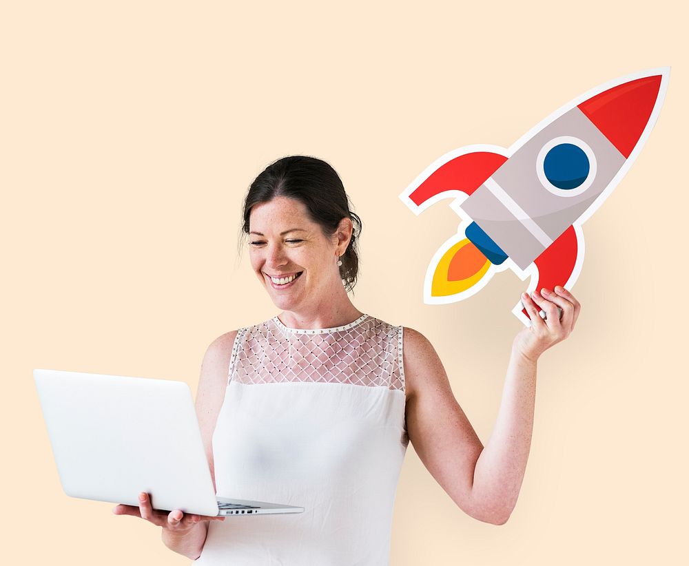 Woman holding a rocket and using a laptop