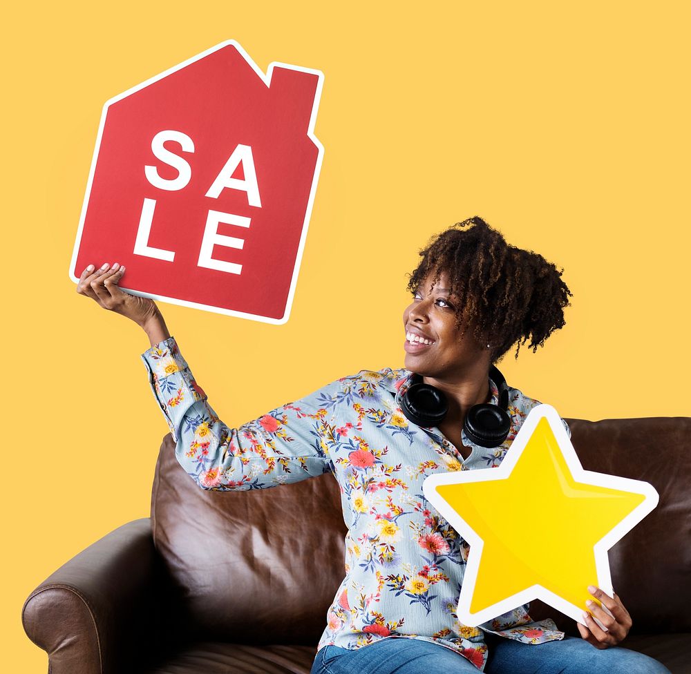 Cheerful woman holding a house sale and star icons