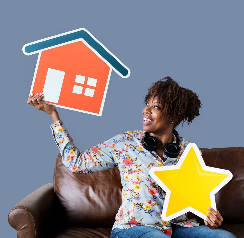Cheerful woman holding a house and star icons