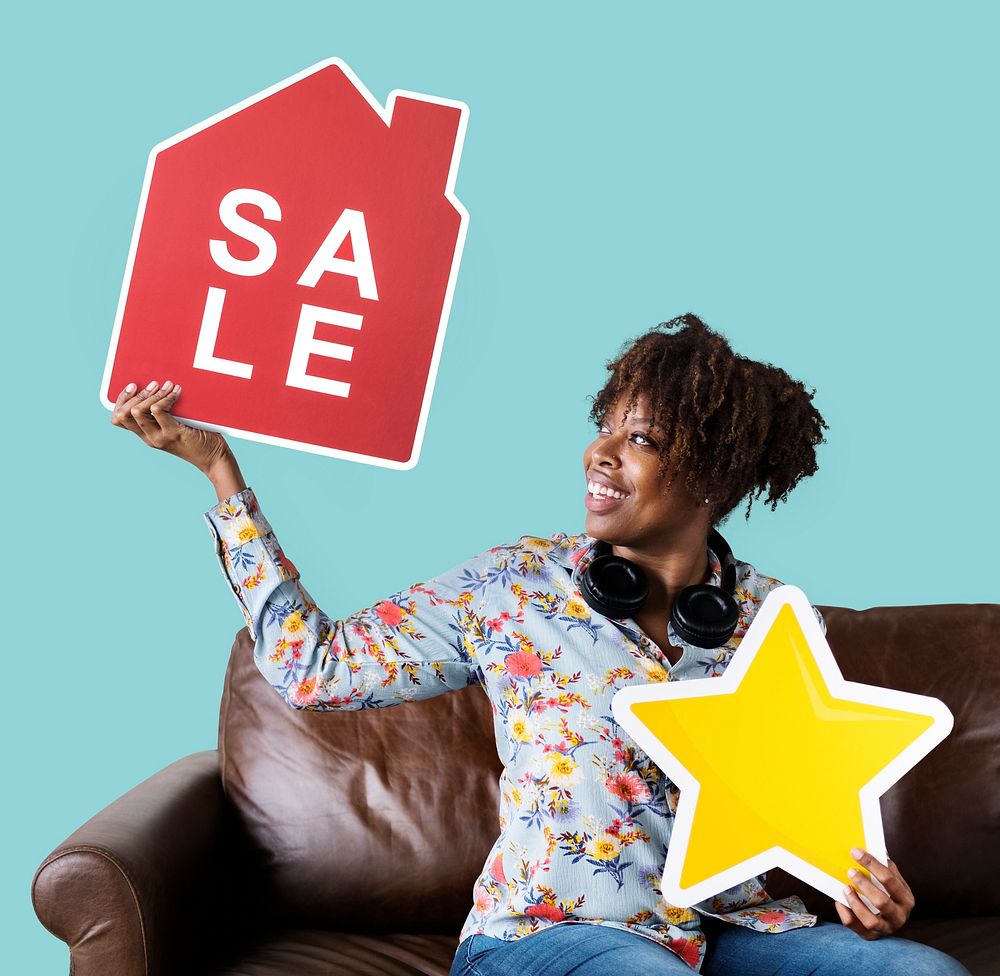Cheerful woman holding a house sale and star icons