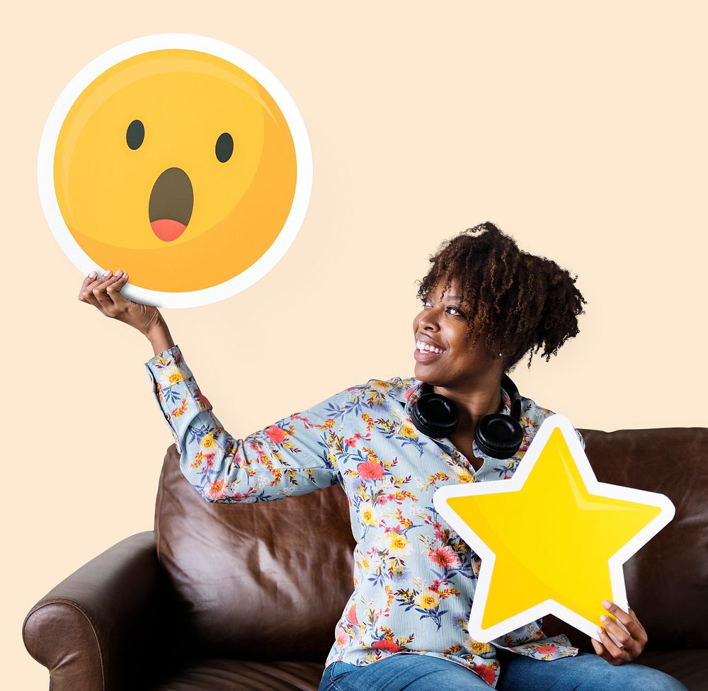 Cheerful woman holding a surprised emoticon and star icons