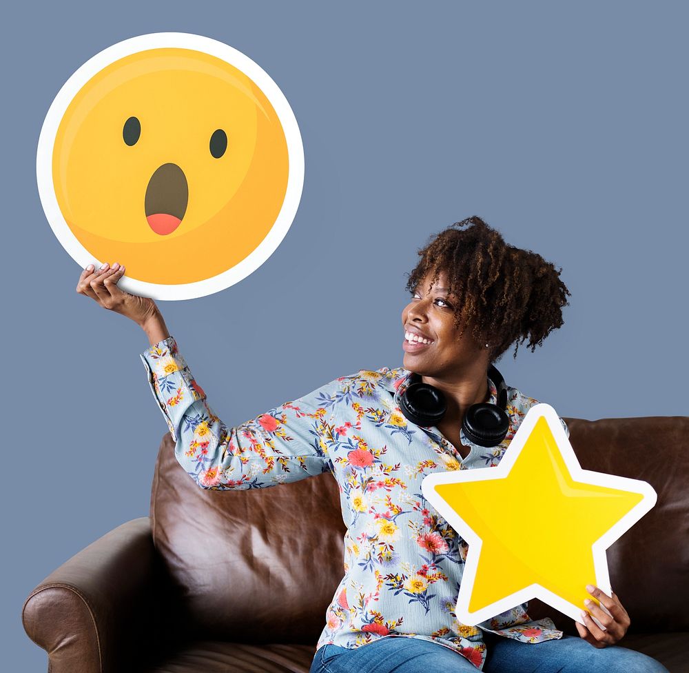 Cheerful woman holding a surprised emoticon and star icons