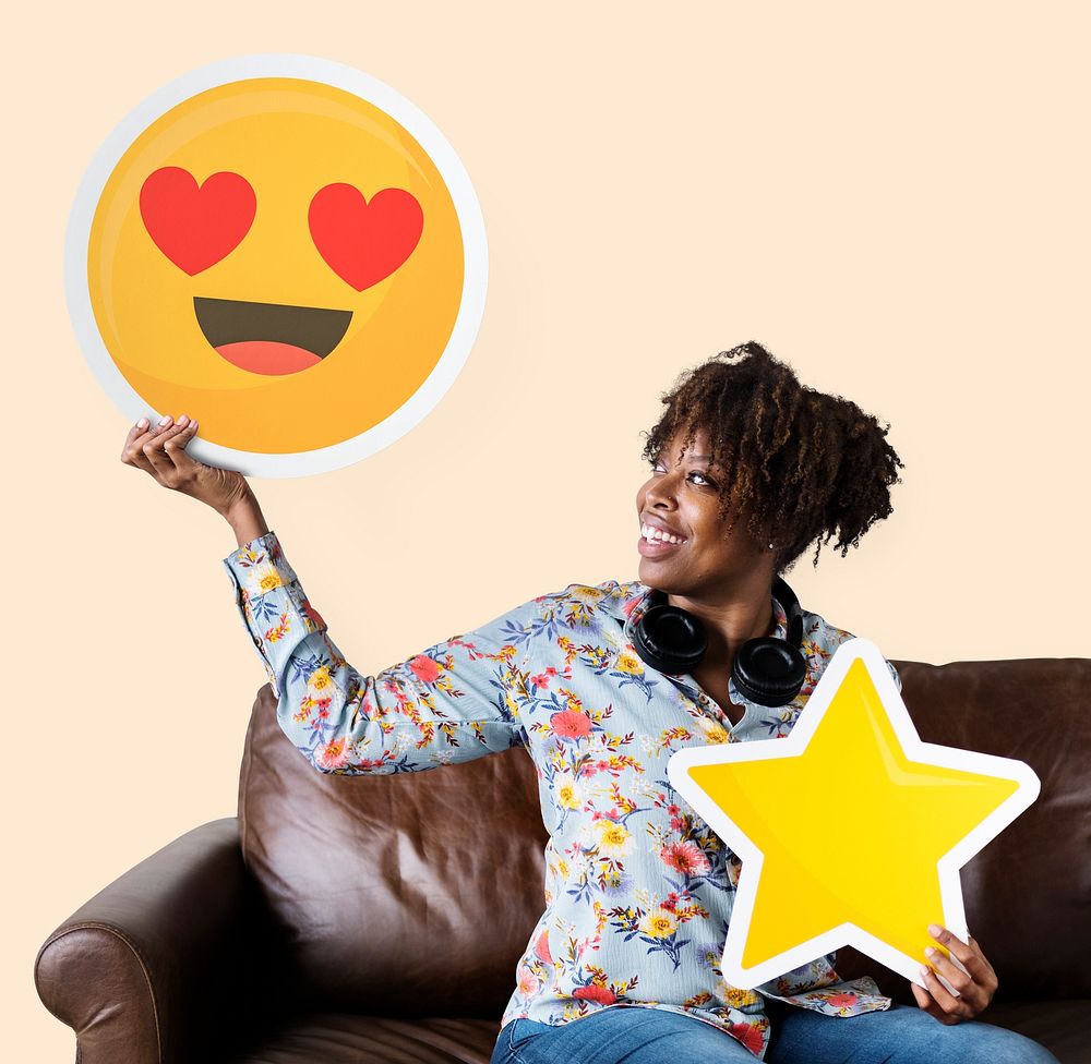 Cheerful woman holding a heart eyes emoticon and star icons
