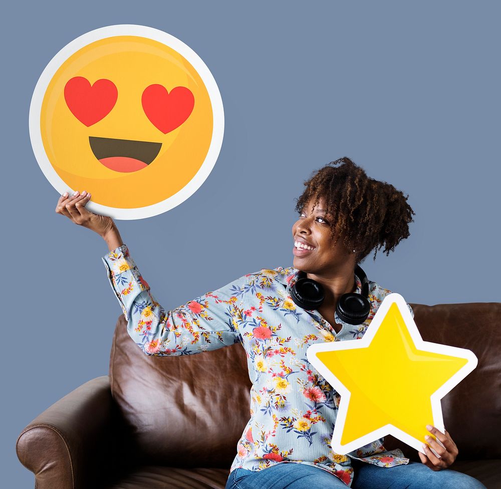 Cheerful woman holding a heart eyes emoticon and star icons
