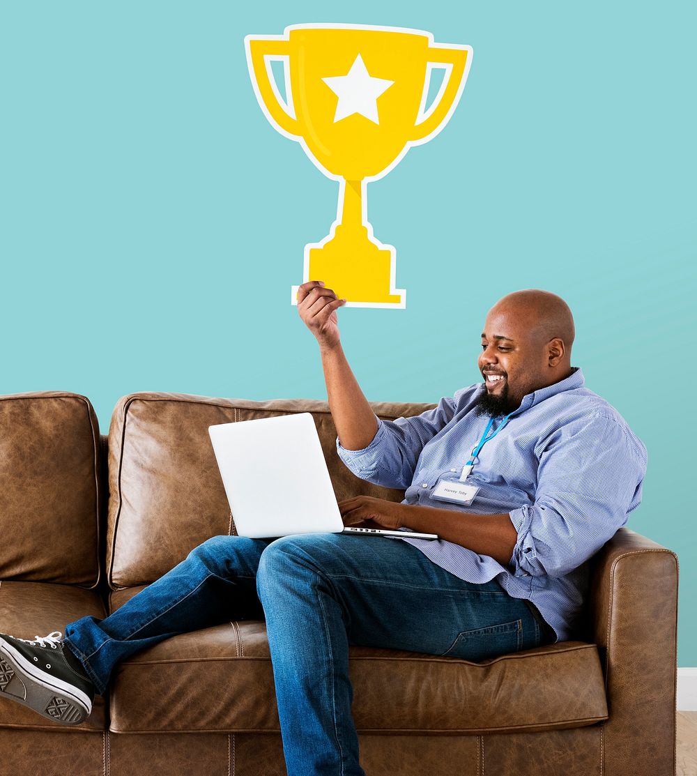 Man showing trophy icon on couch