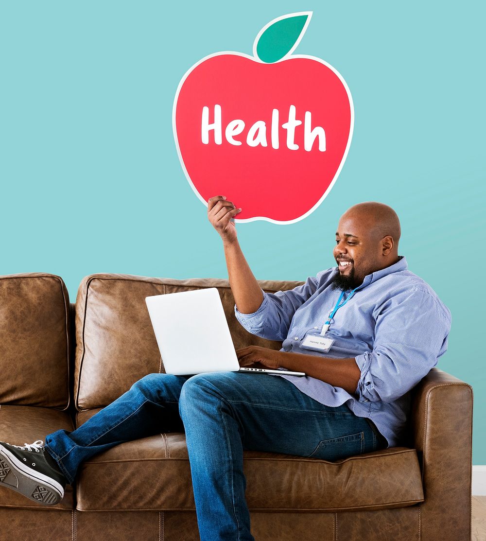 Man showing healthy apple icon on couch