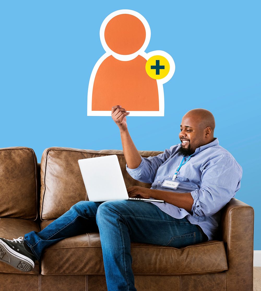Man showing friend request icon on couch