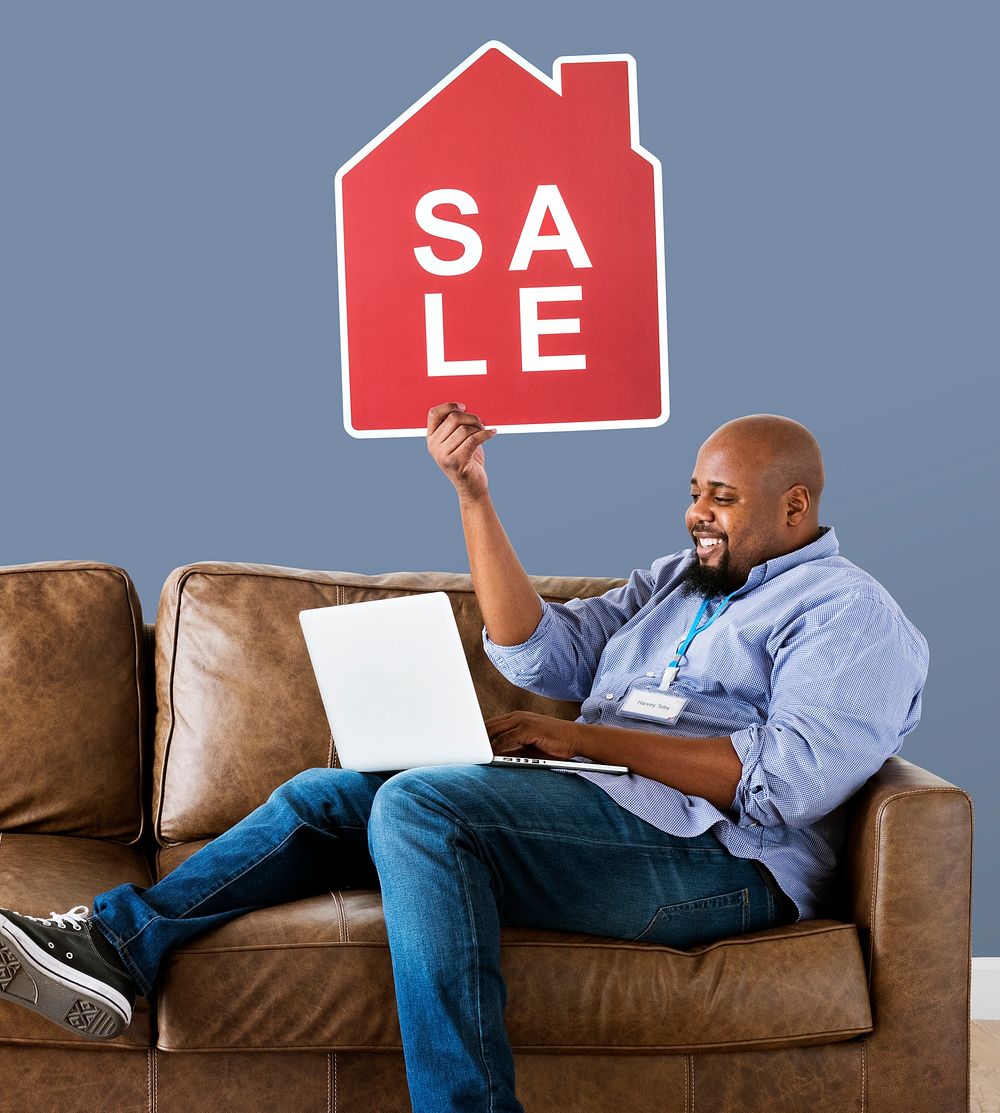 Man holding a house sale icon