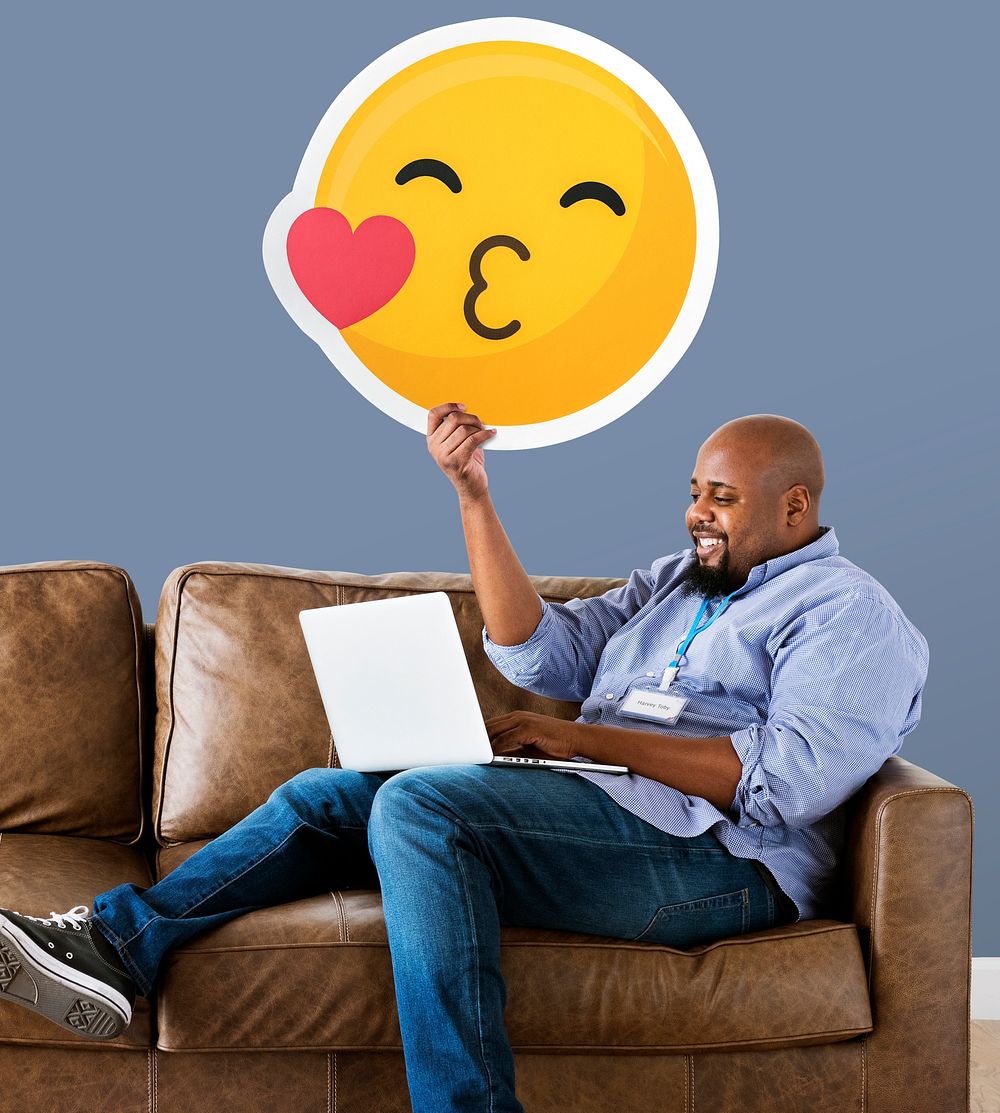 Man showing a kissing emoticon