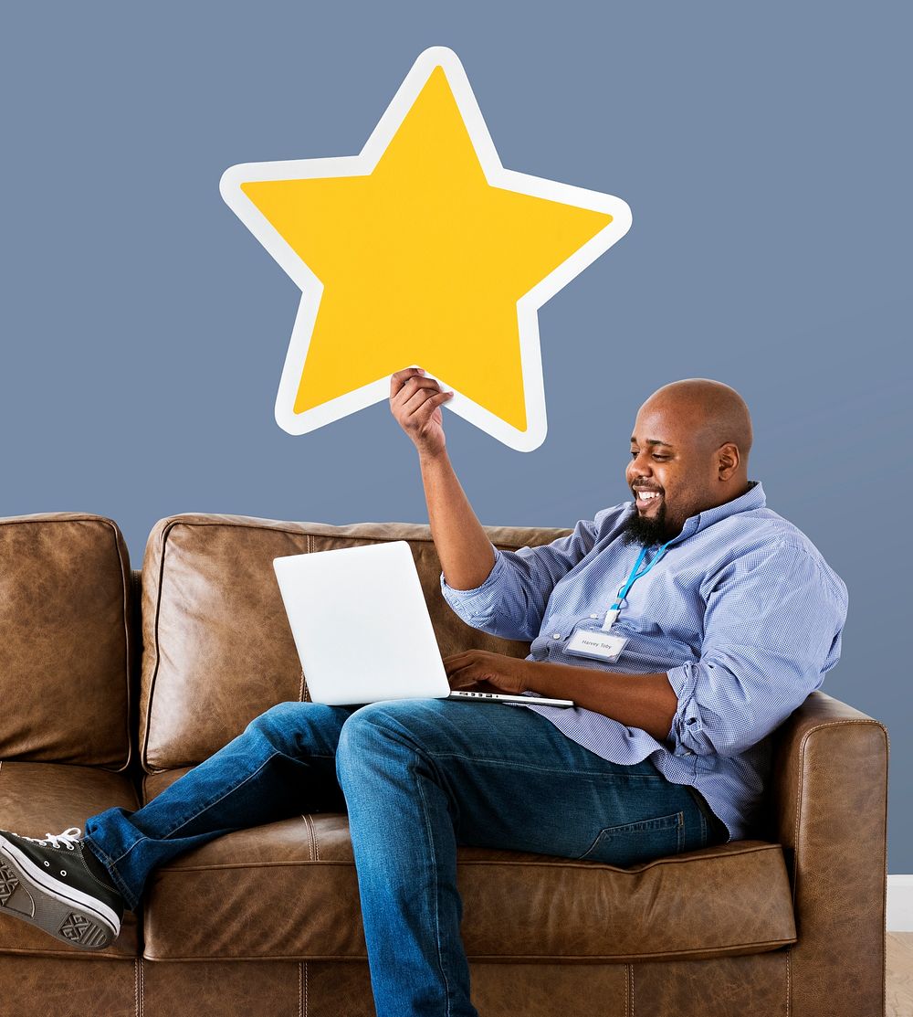 Man showing golden star icon on couch