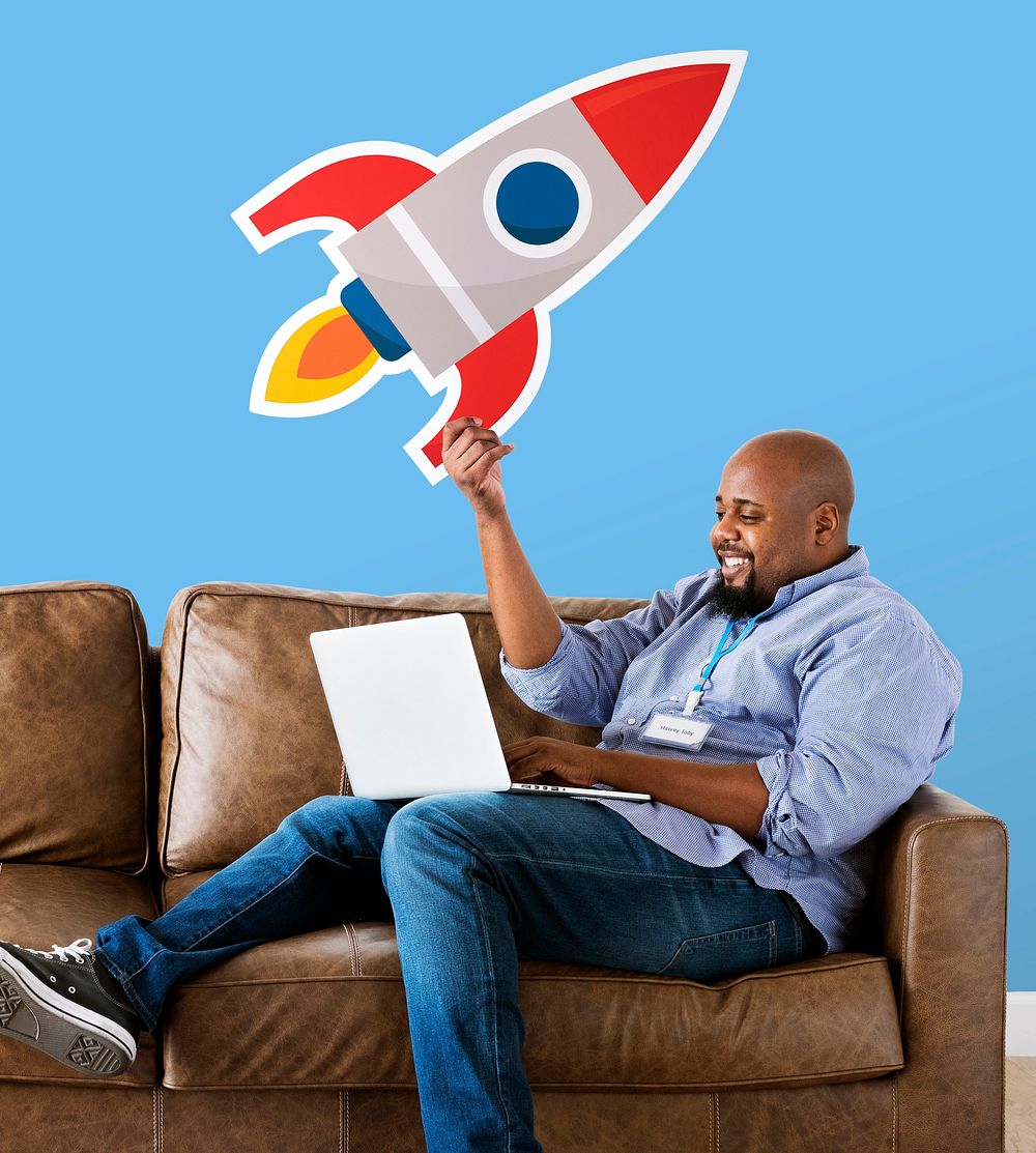 Man showing a technology icon on couch