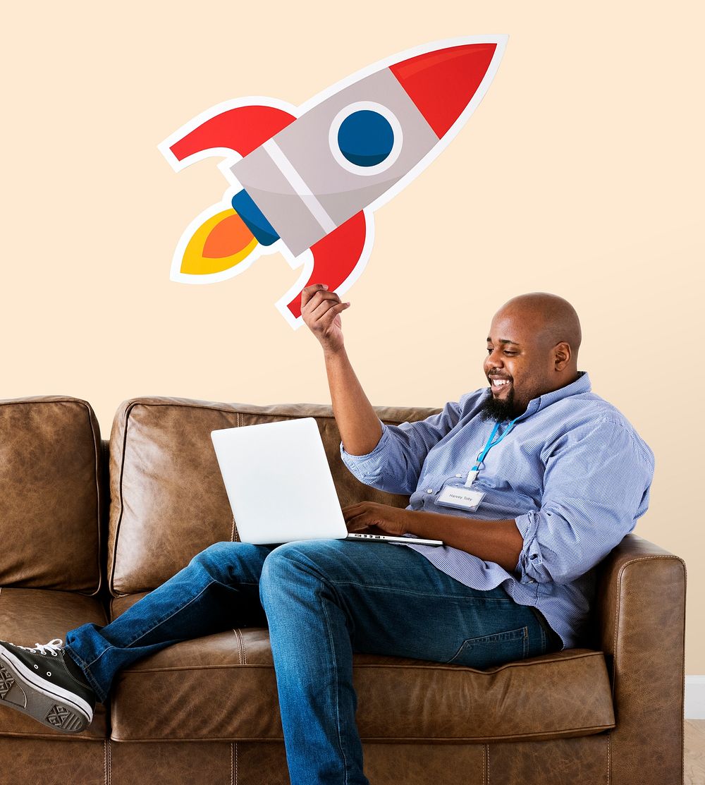 Man showing a technology icon on couch