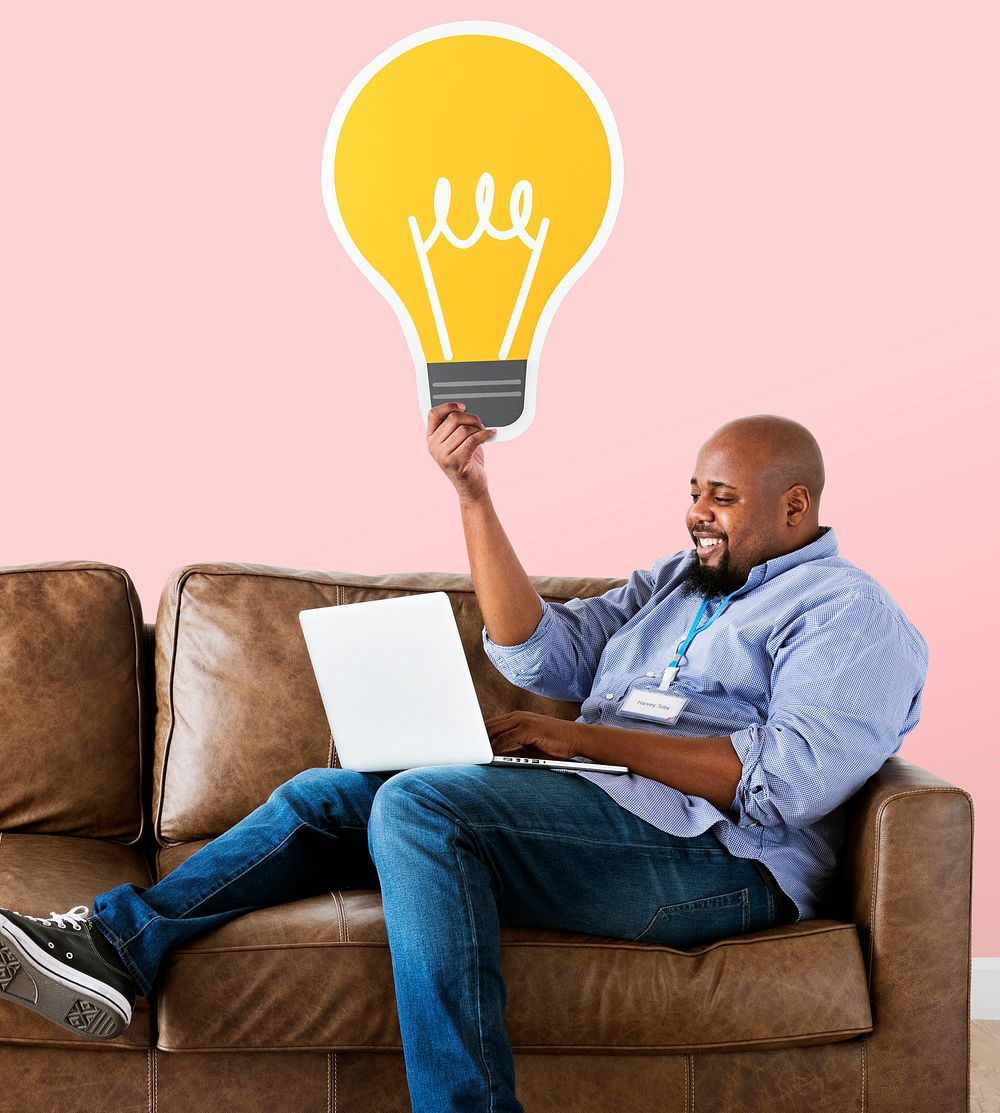 Man showing a light bulb icon on couch