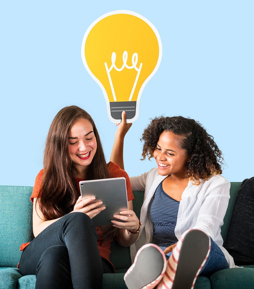Women holding a light bulb icon and using a tablet