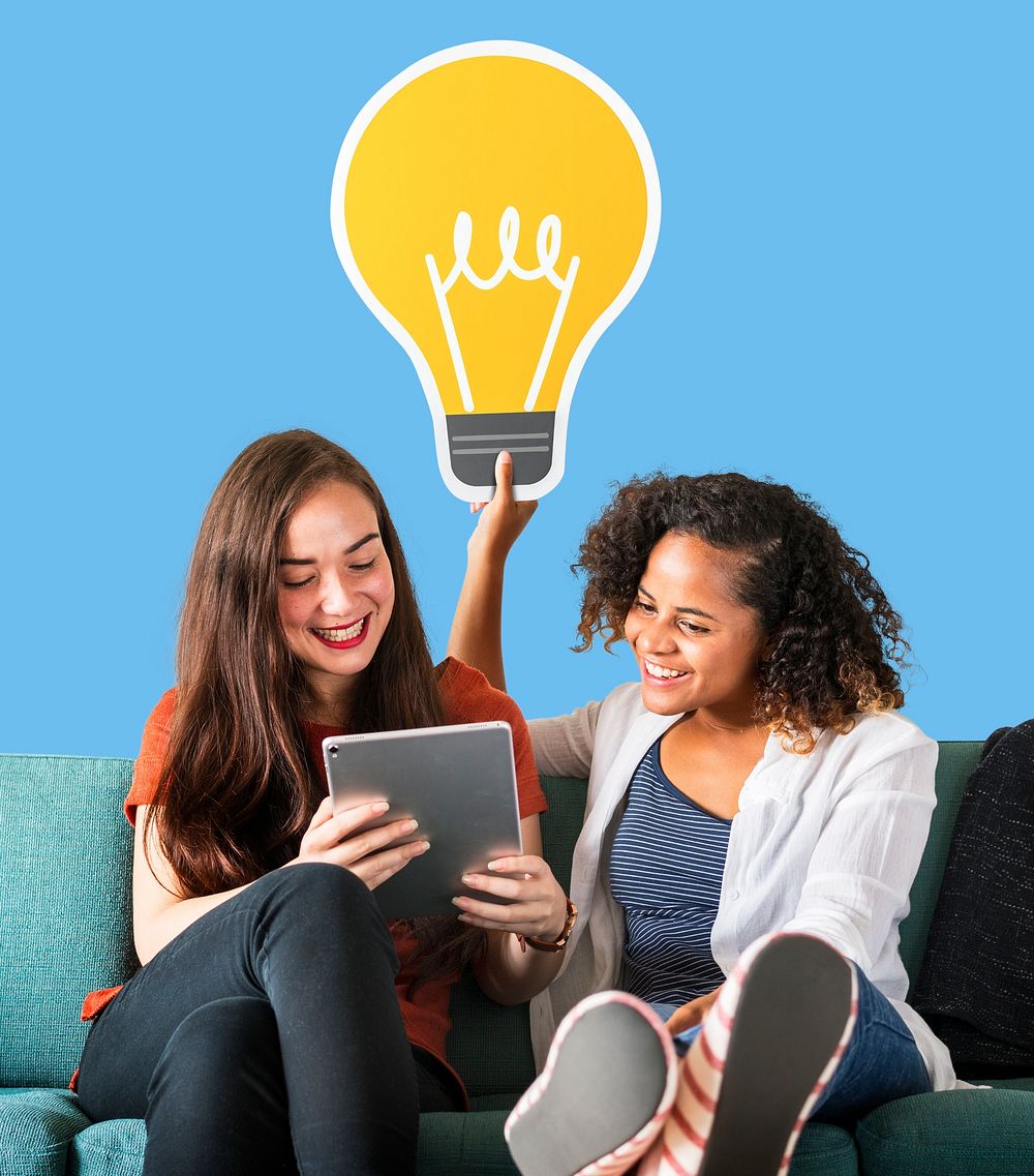 Women holding a light bulb icon and using a tablet