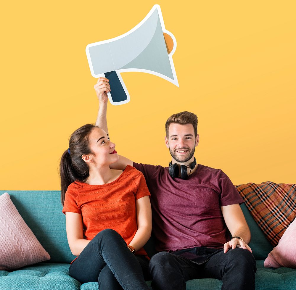 Cheerful couple holding a megaphone icon