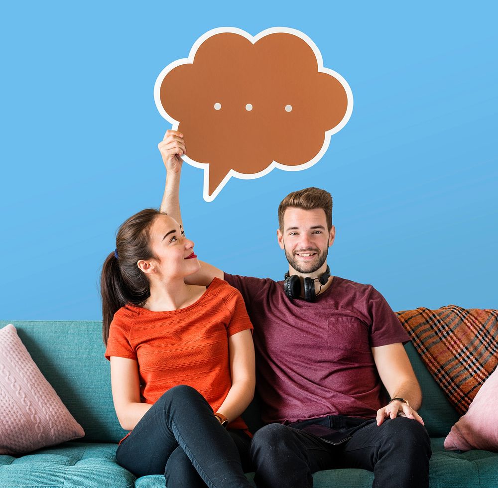 Cheerful couple holding a brown speech bubble icon