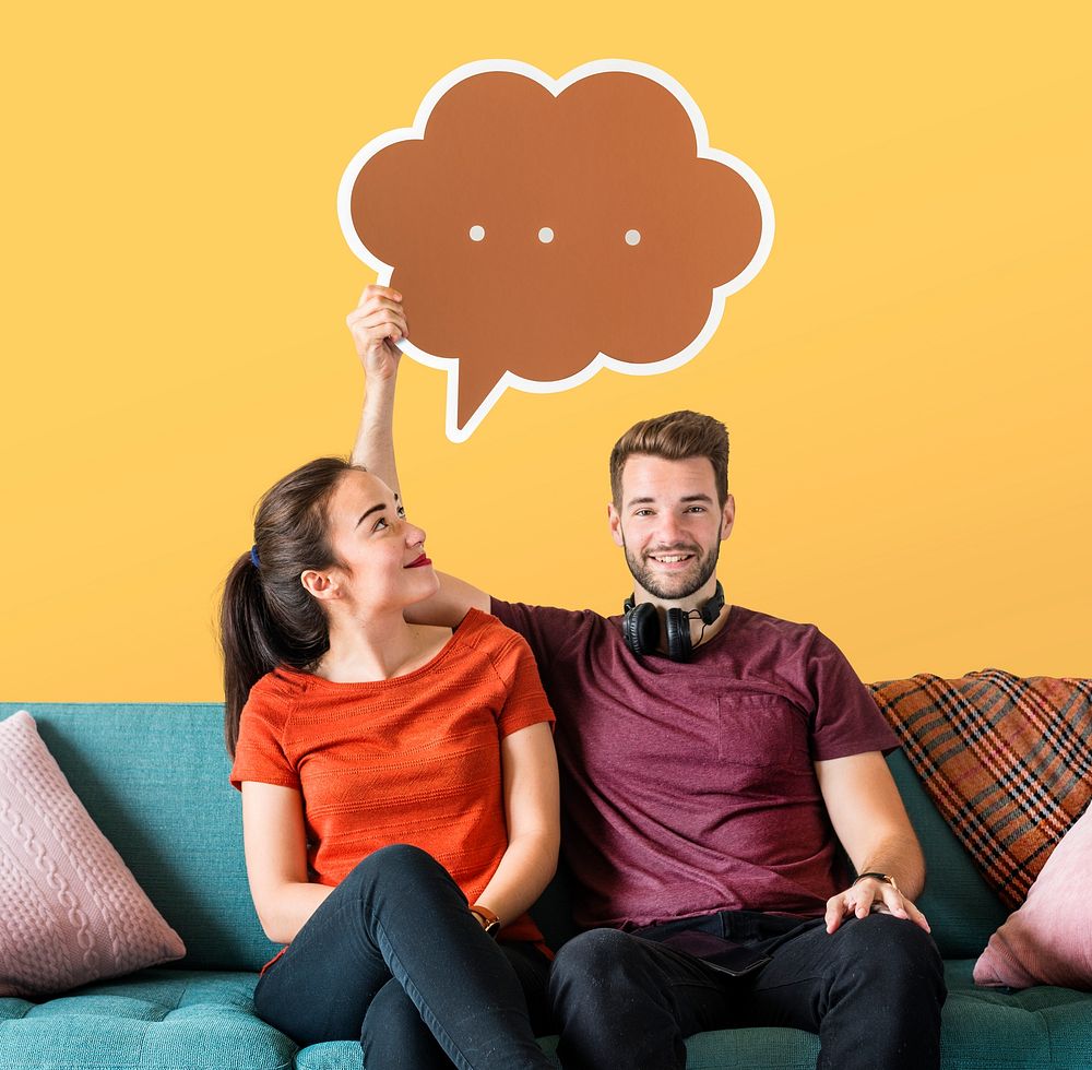 Cheerful couple holding a brown speech bubble icon