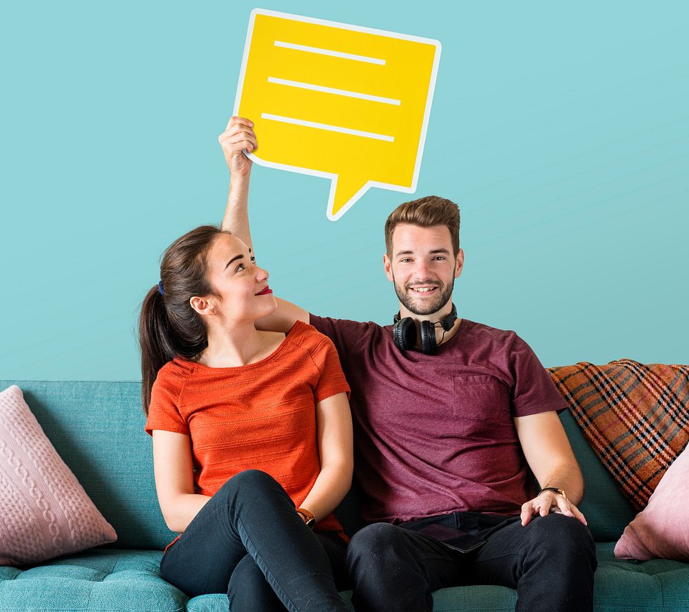 Cheerful couple holding a yellow speech bubble icon