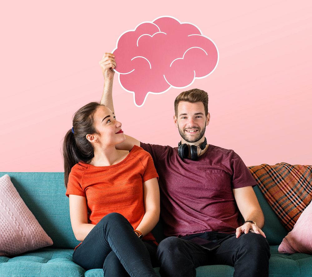 Cheerful couple holding a pink brain icon