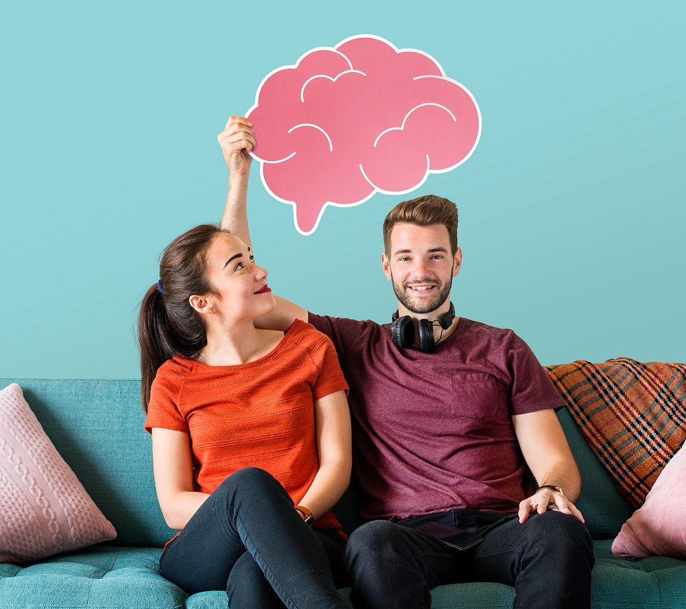 Cheerful couple holding a pink brain icon