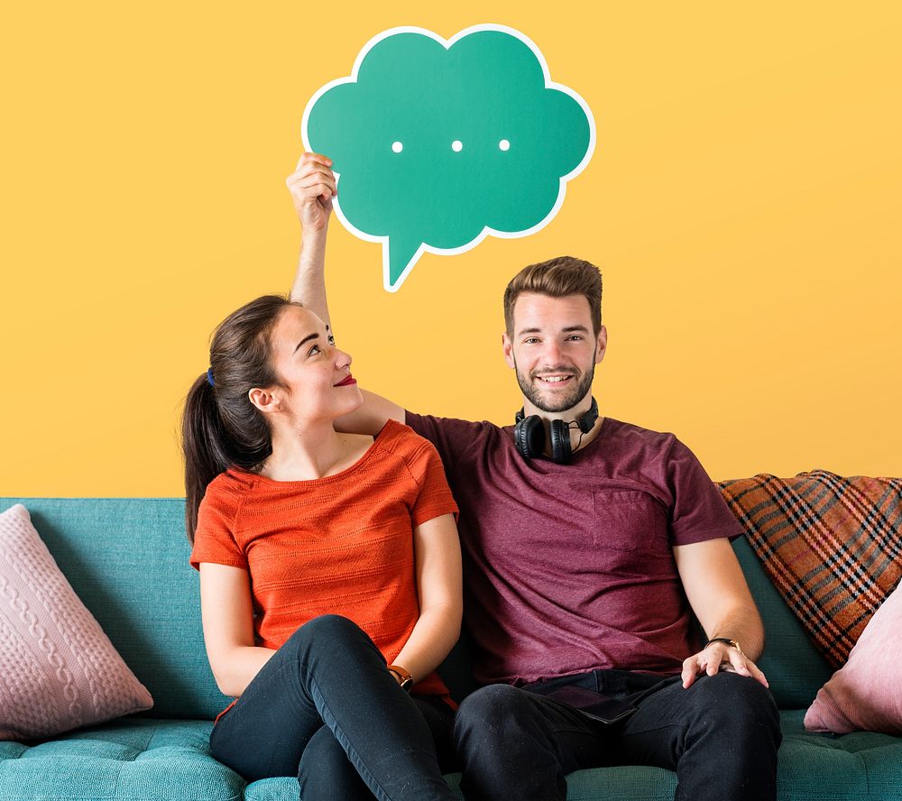 Cheerful couple holding a green speech bubble icon