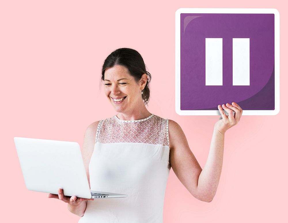 Woman holding a pause icon and a laptop