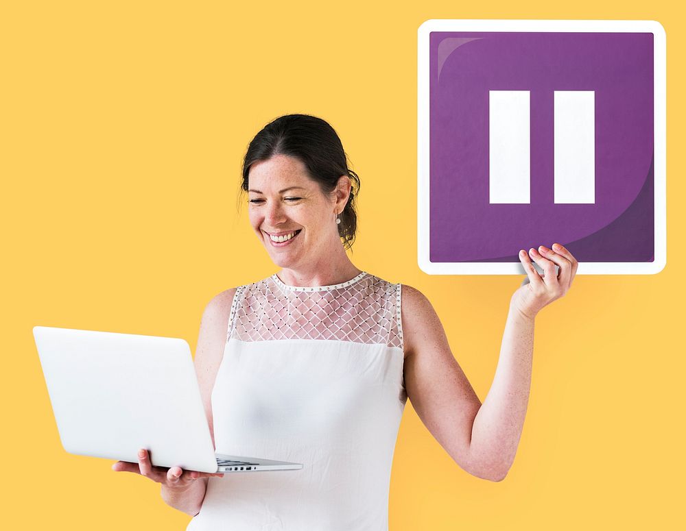 Woman holding a pause icon and a laptop