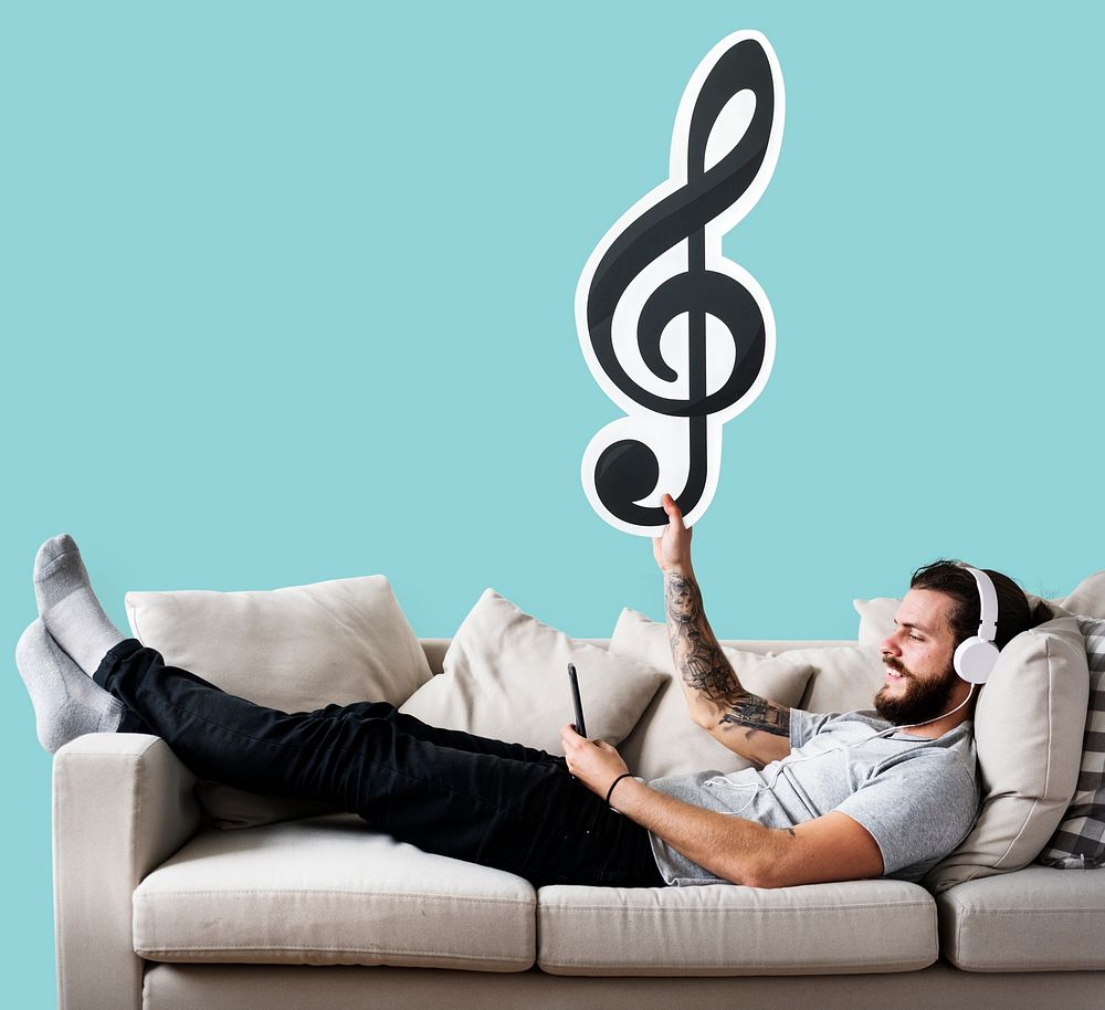 Man holding an icon on a couch