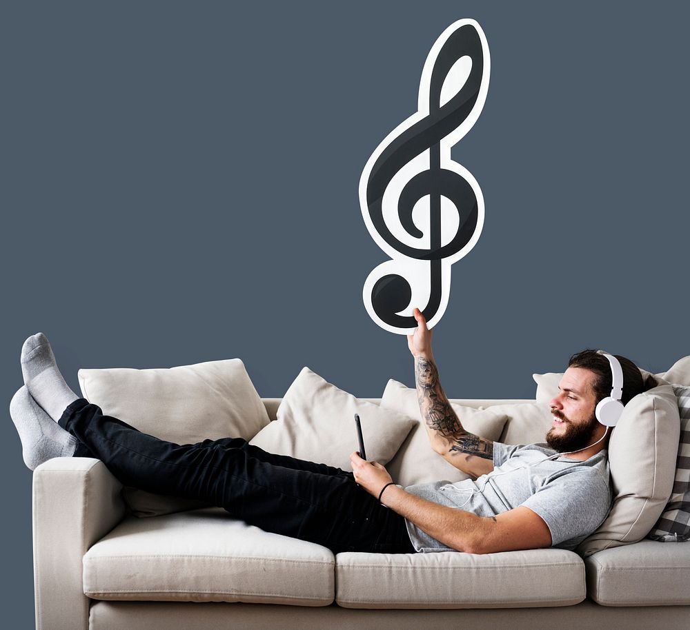 Man holding an icon on a couch