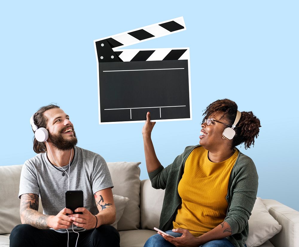 Interracial couple listening to music and holding a clapper icon