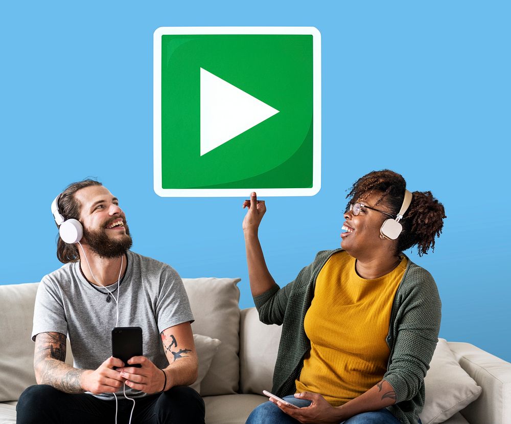 Interracial couple listening to music and holding a play button