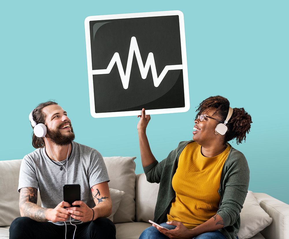 Interracial couple listening to music and holding a frequency icon