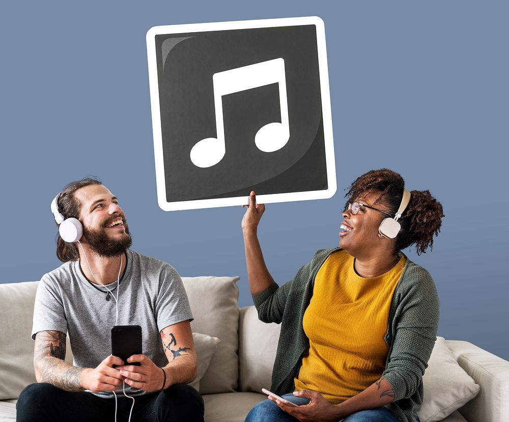 Interracial couple listening to music and holding a musical note