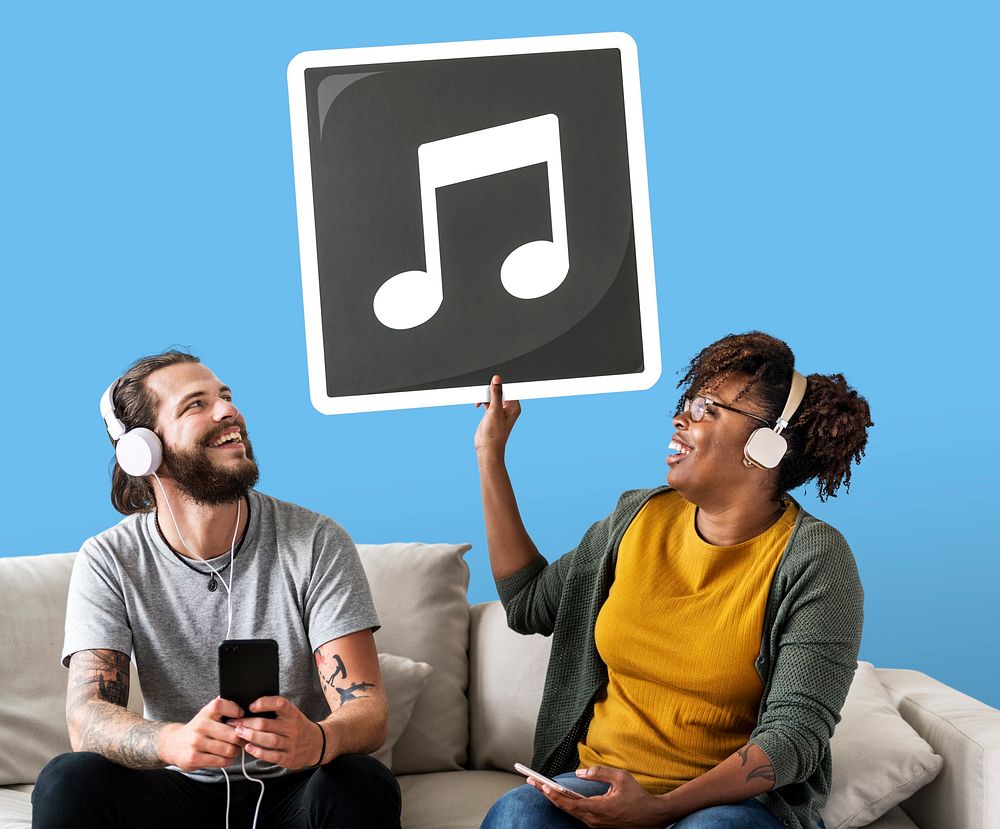 Interracial couple listening to music and holding a musical note