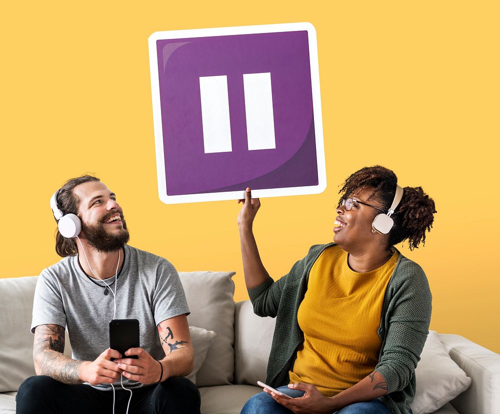 Interracial couple listening to music and holding a pause button