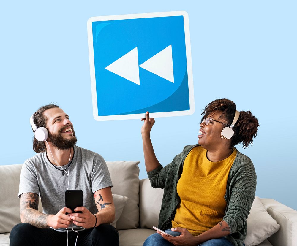 Interracial couple listening to music and holding a rewind button