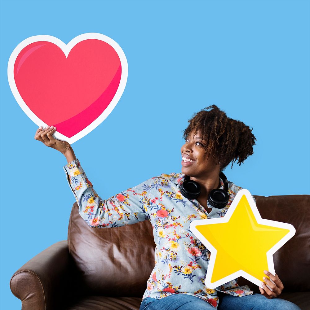 African American woman holding a heart emoticon