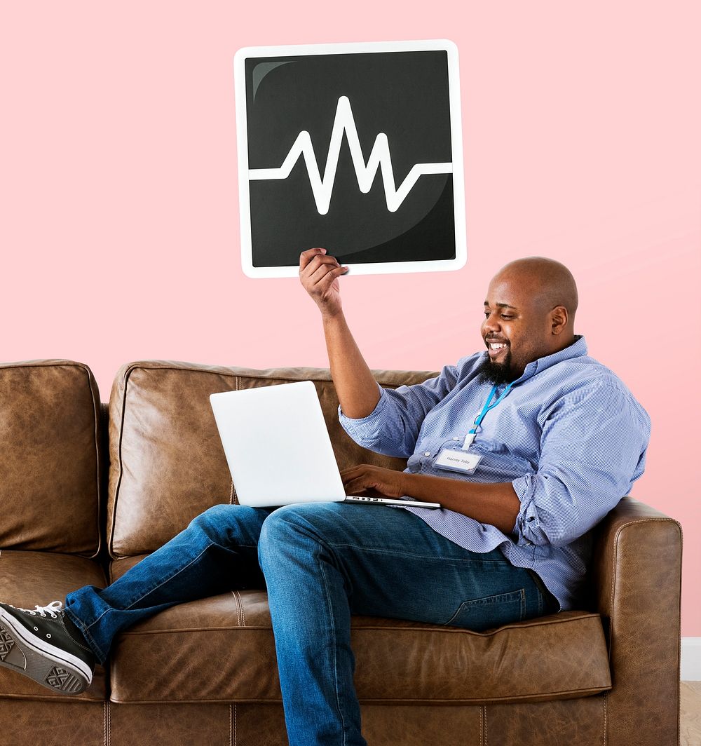Man using a laptop and holding a frequency icon