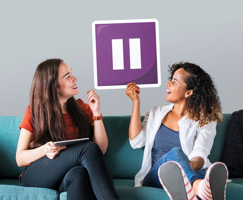 Females on a couch holding an icon