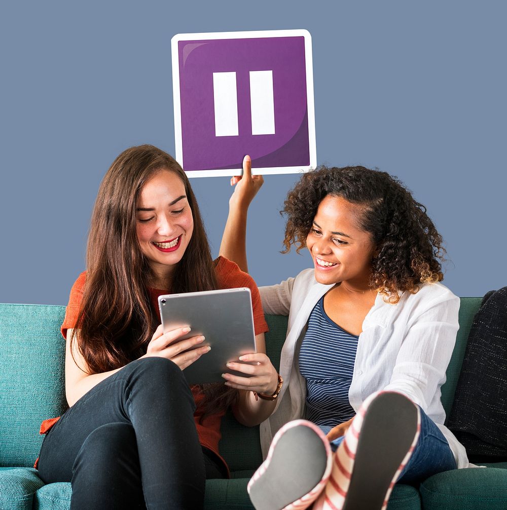 Young female friends holding a pause icon
