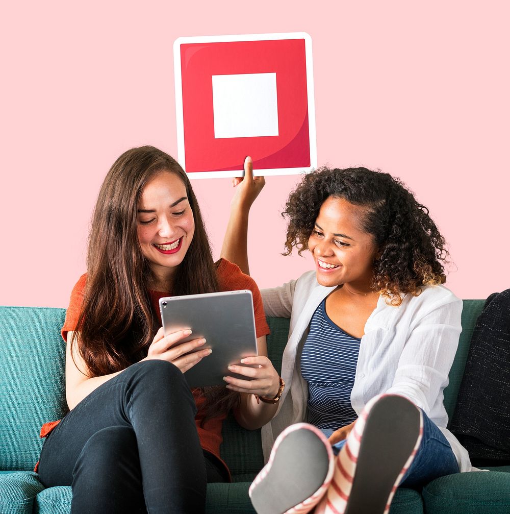 Young female friends holding a stop icon