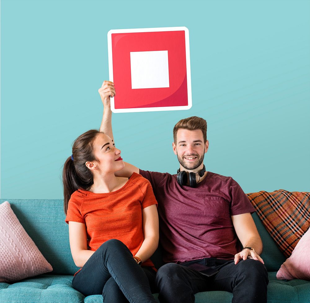 Young couple holding a stop button icon