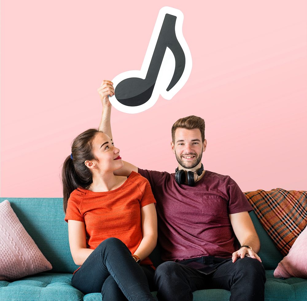 Young couple holding a musical note icon