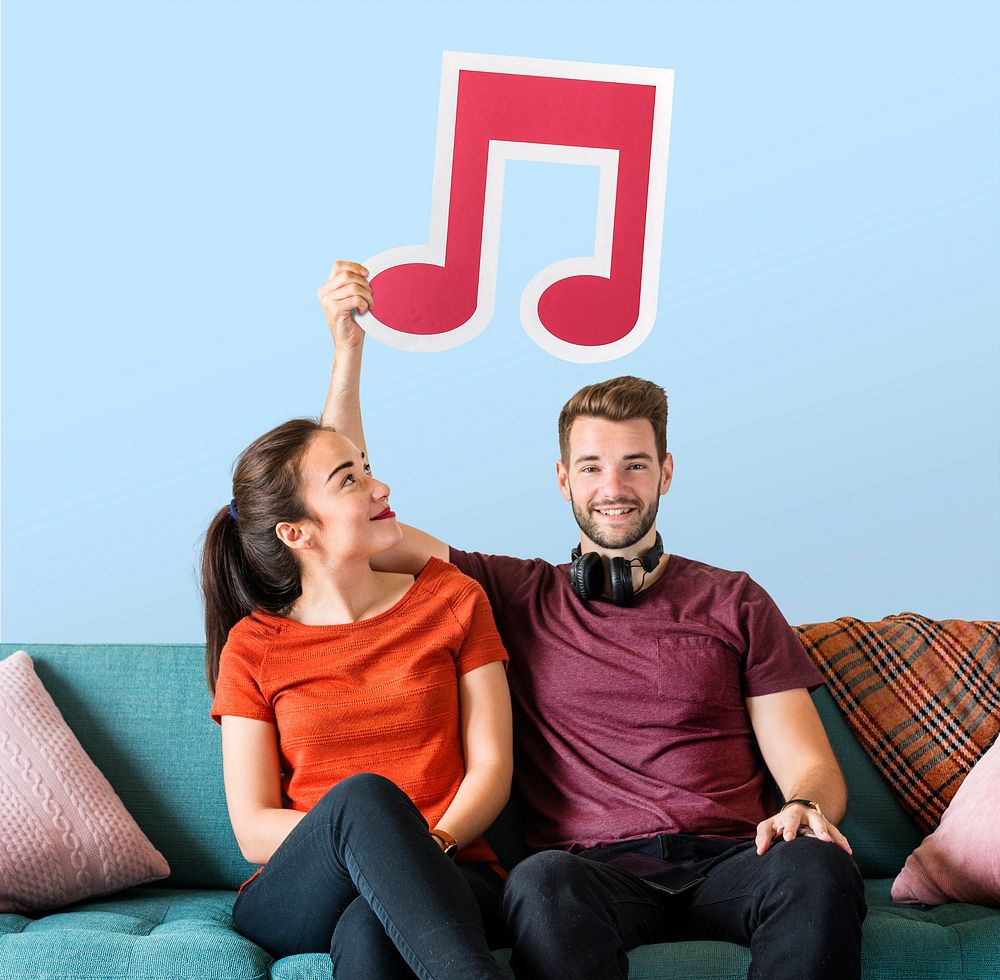 Young couple holding a musical note icon