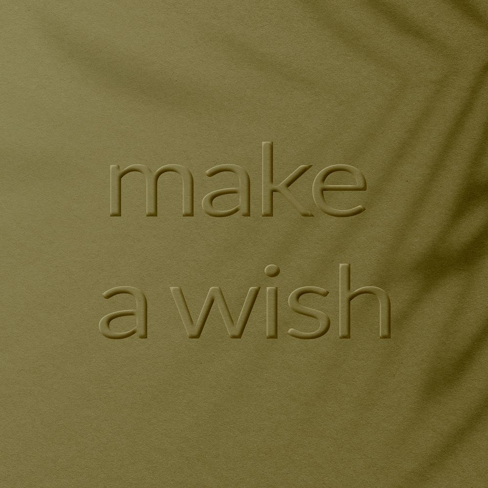 Textured concrete background message embossed make a wish typography